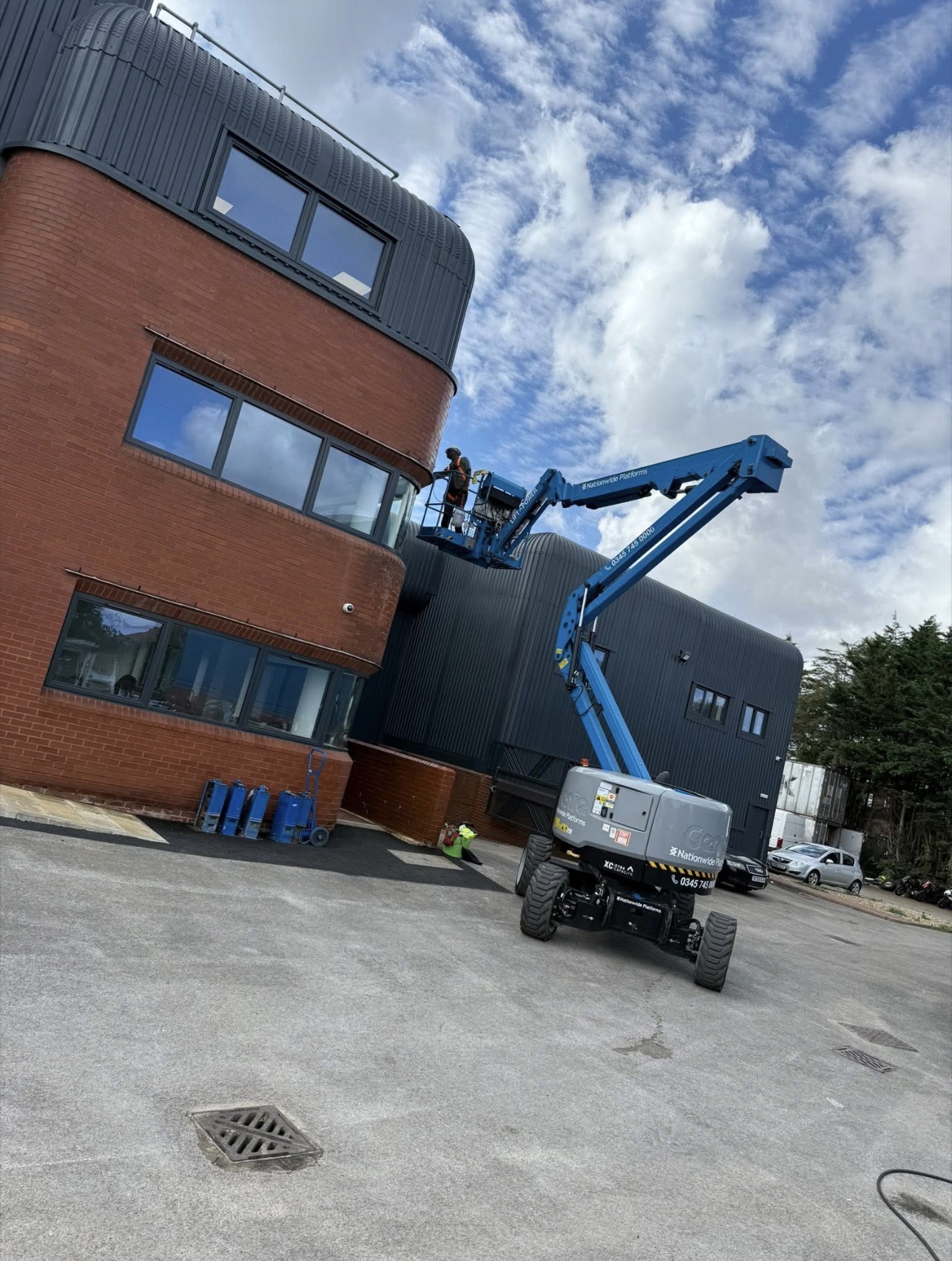 Mobile elevated work platform providing access to the upper level of a commercial building