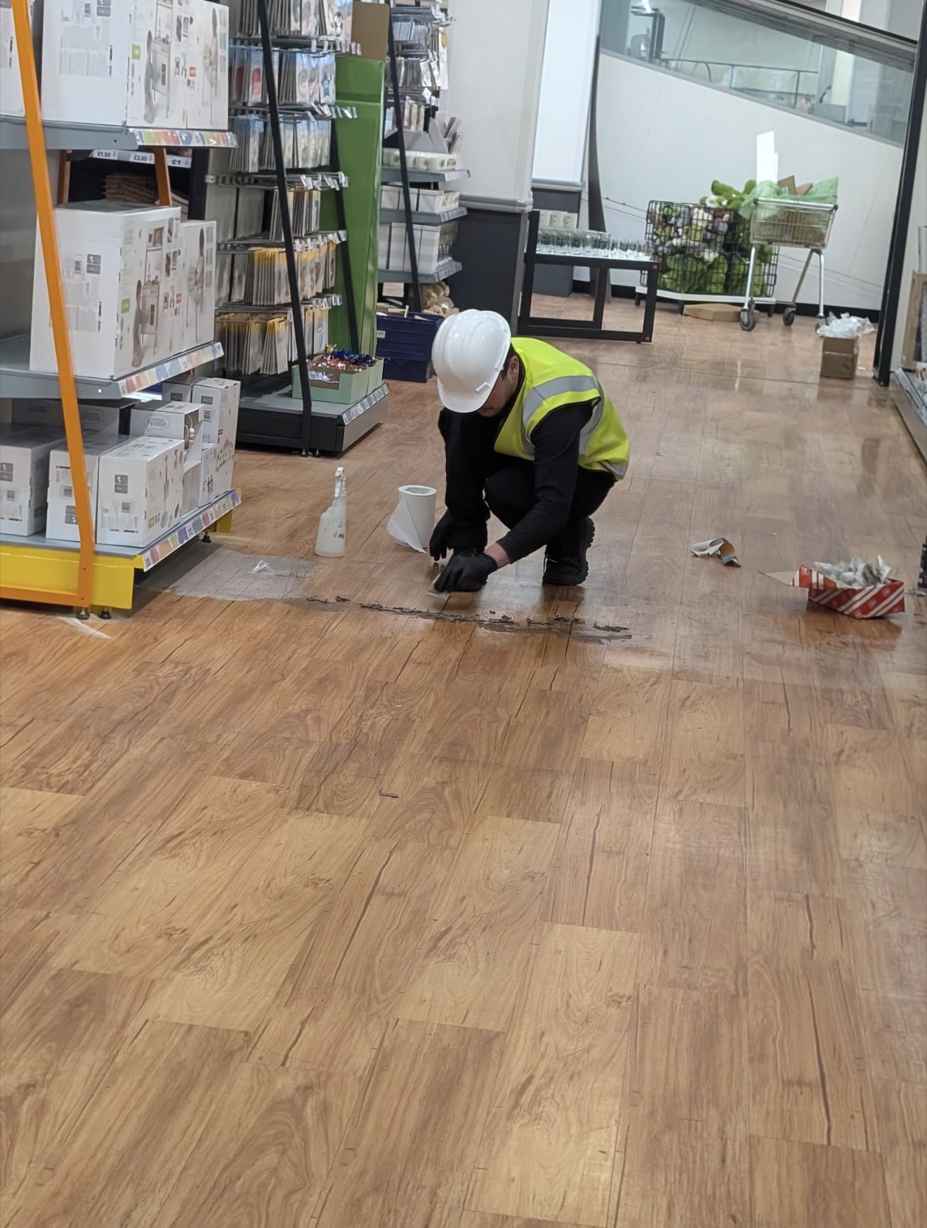 Operative completing detailed floor work in an active retail environment