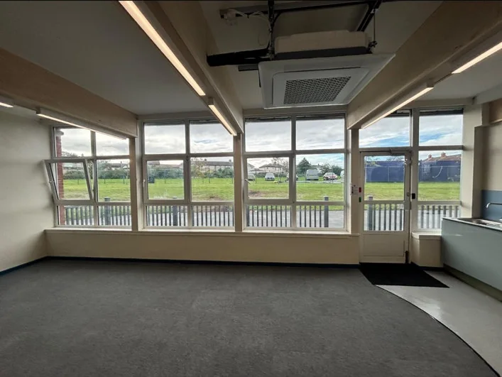 Grey-carpeted classroom with large windows at Hatton Hill School in Litherland