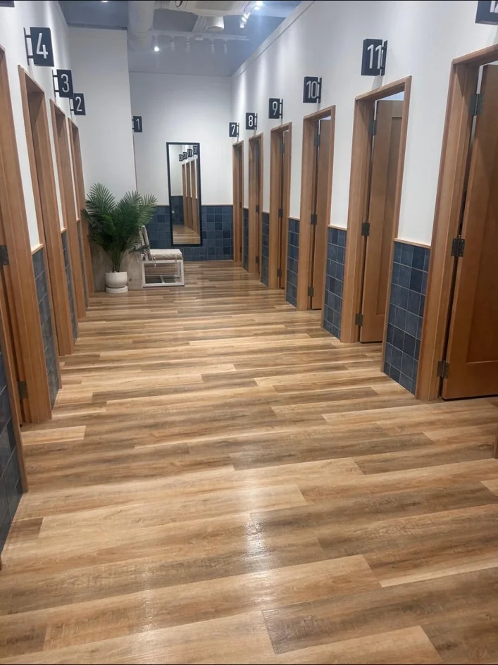 Fitting-room corridor with timber-effect flooring at Hollister, Liverpool ONE